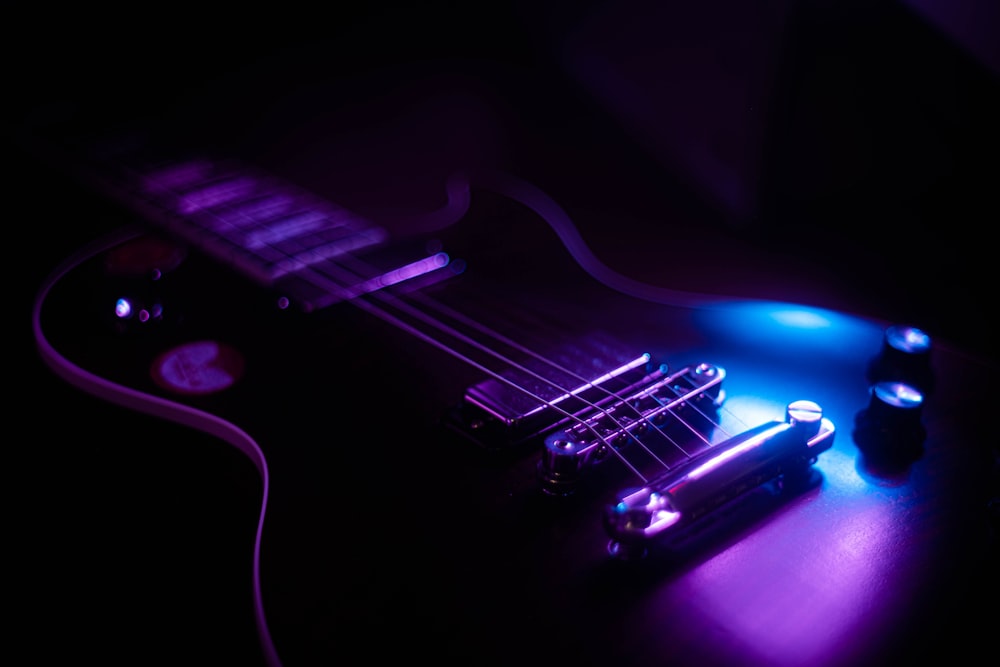 purple and black electric guitar