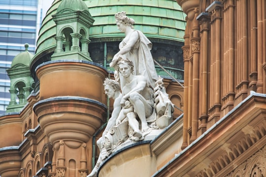 gray concrete statue of man in Queen Victoria Building Australia