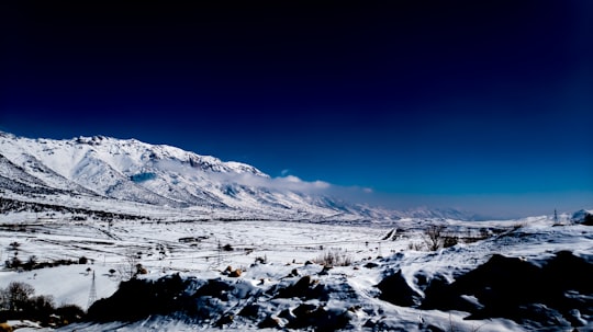 snow covered mountain under blue sky during daytime in Kermanshah Iran