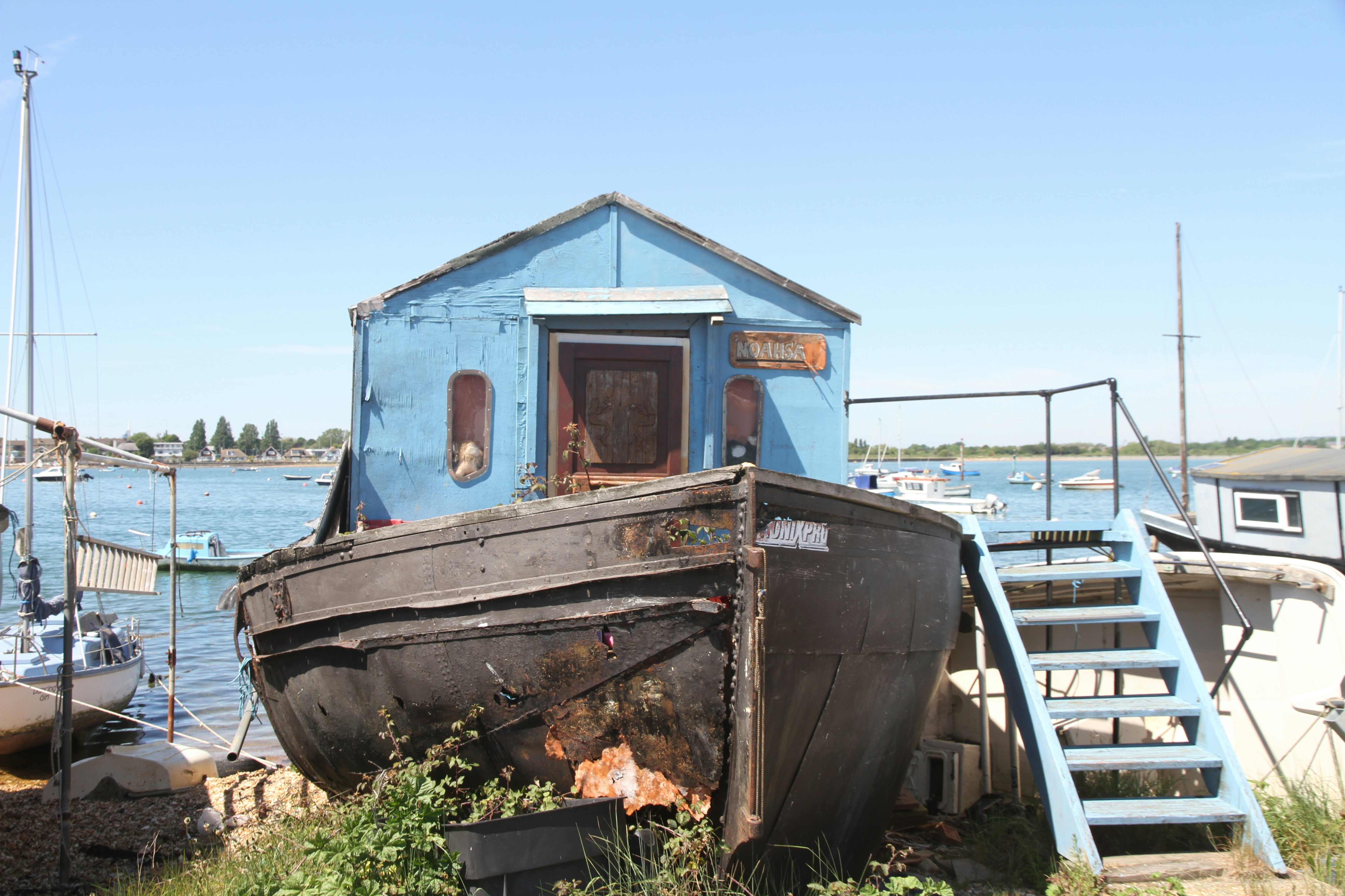 blue and white boat on body of water during daytime