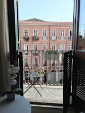 Spacious deluxe room featuring elegant decor and a private balcony with garden views.