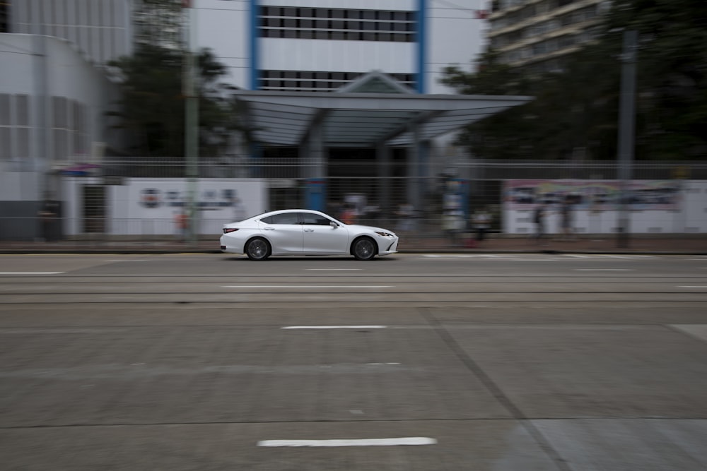 white coupe on road during daytime