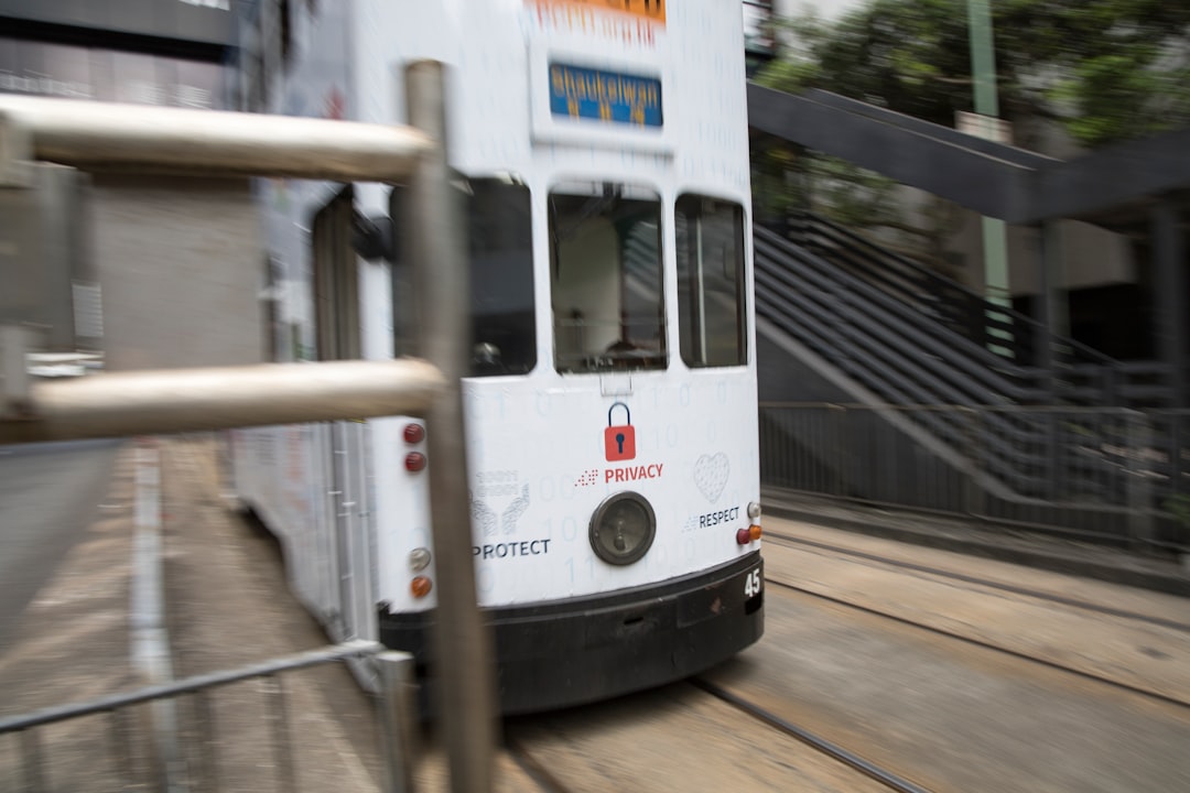 white tram on the road during daytime