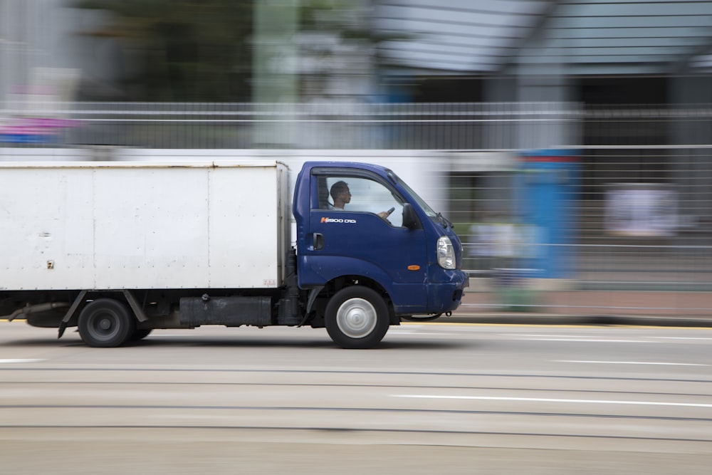 blue and white van on road during daytime