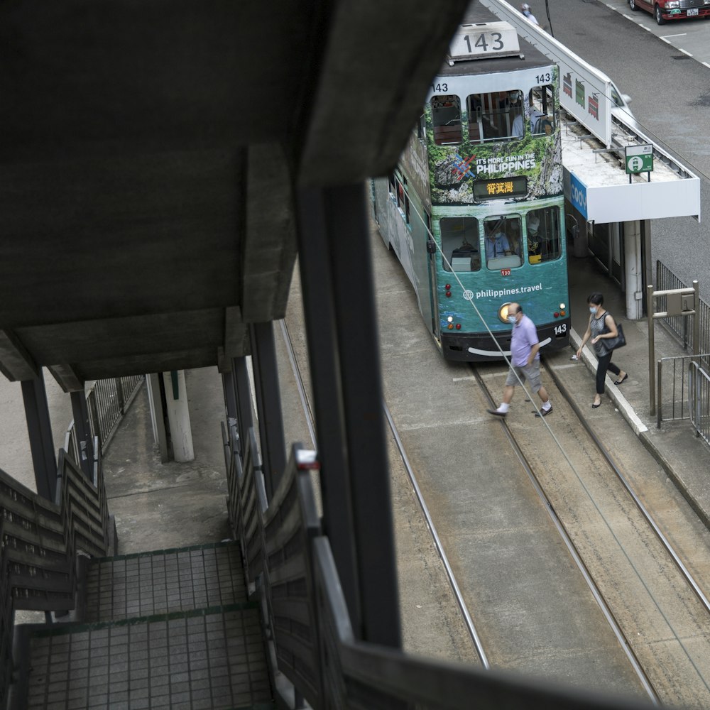 green and blue bus on road during daytime