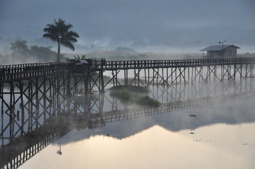 gray wooden bridge over river