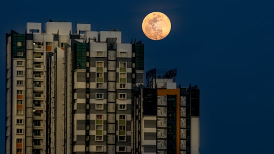 full moon over white and black concrete building in Chennai India