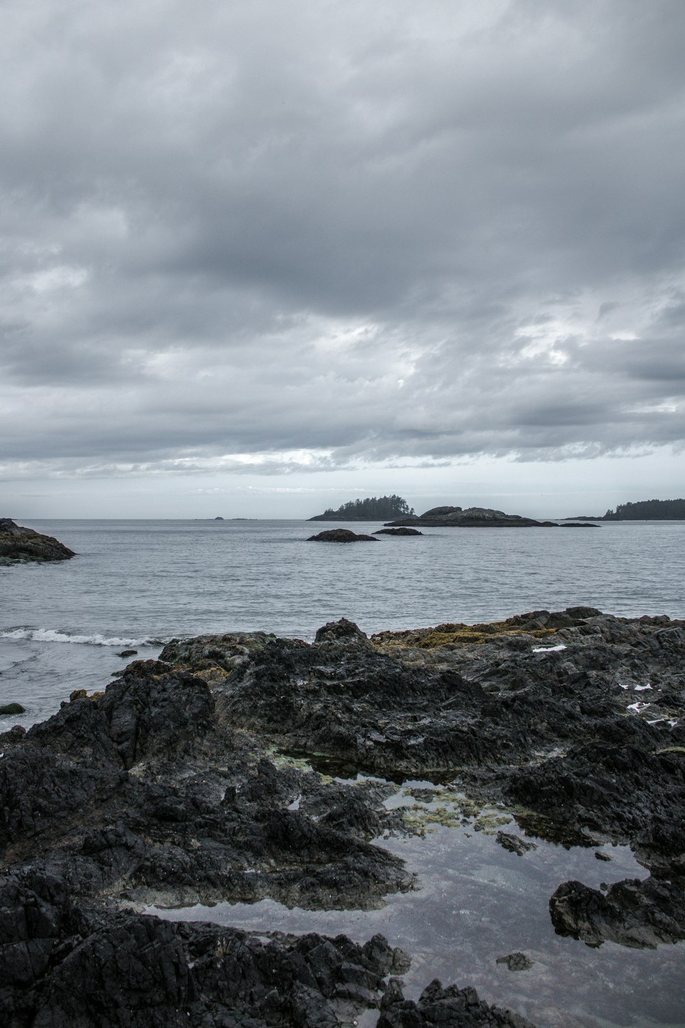 white and black ship on sea under cloudy sky during daytime