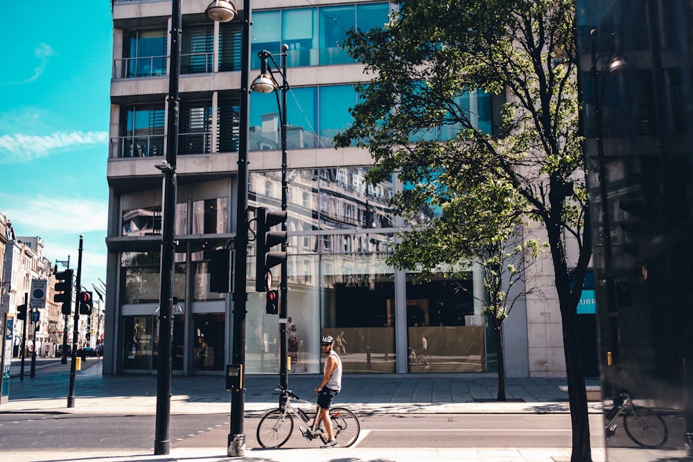 man in black shirt riding bicycle on road during daytime