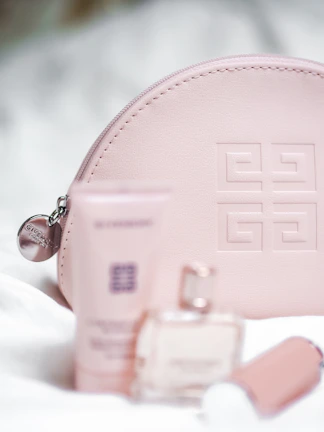 Elegant burgundy velvet pouch partially open revealing a discreet wellness product inside.