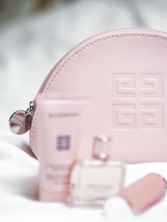 Elegant display of luxury cosmetic products with soft pink and gold accents.