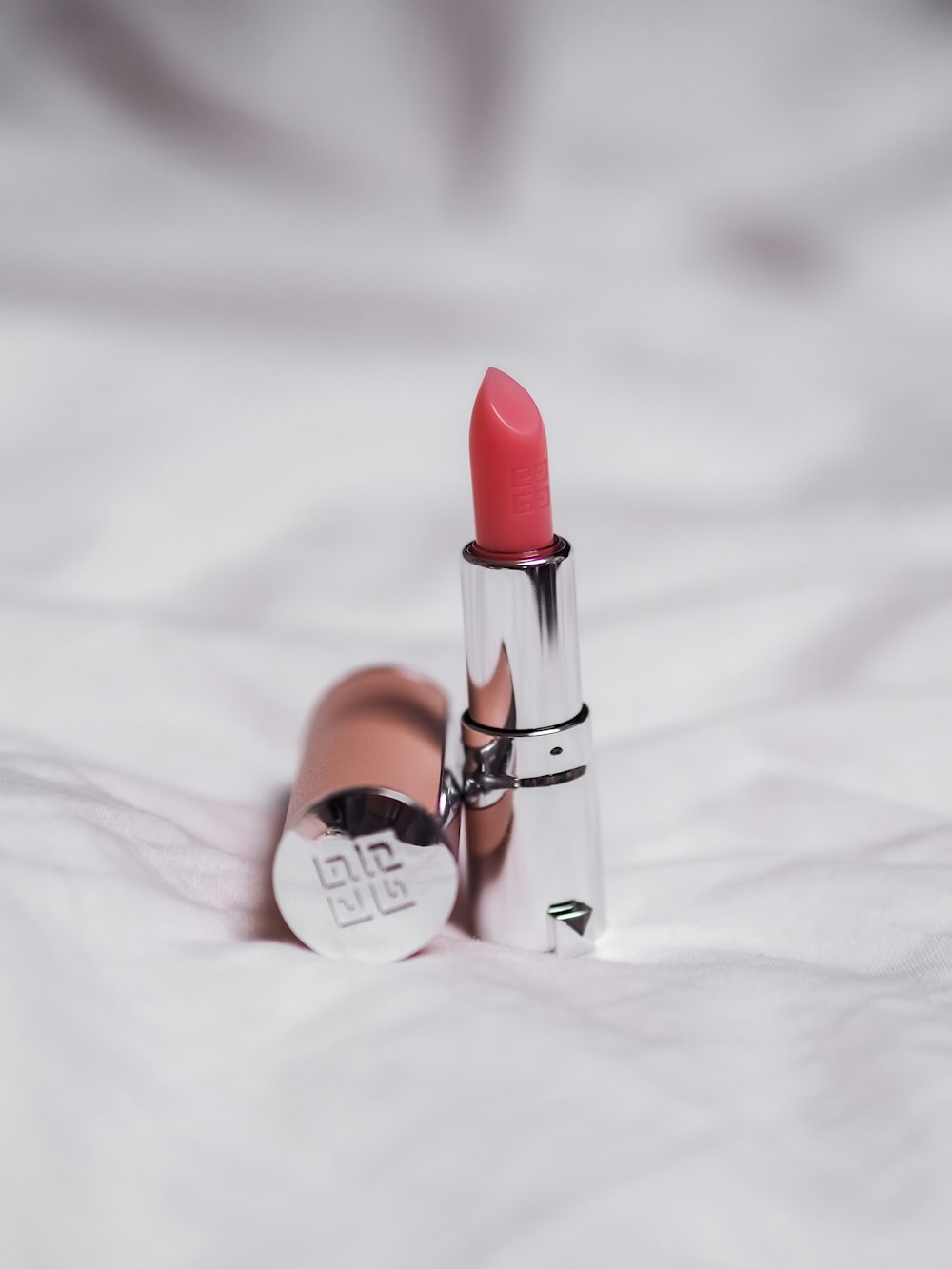 red lipstick on white textile