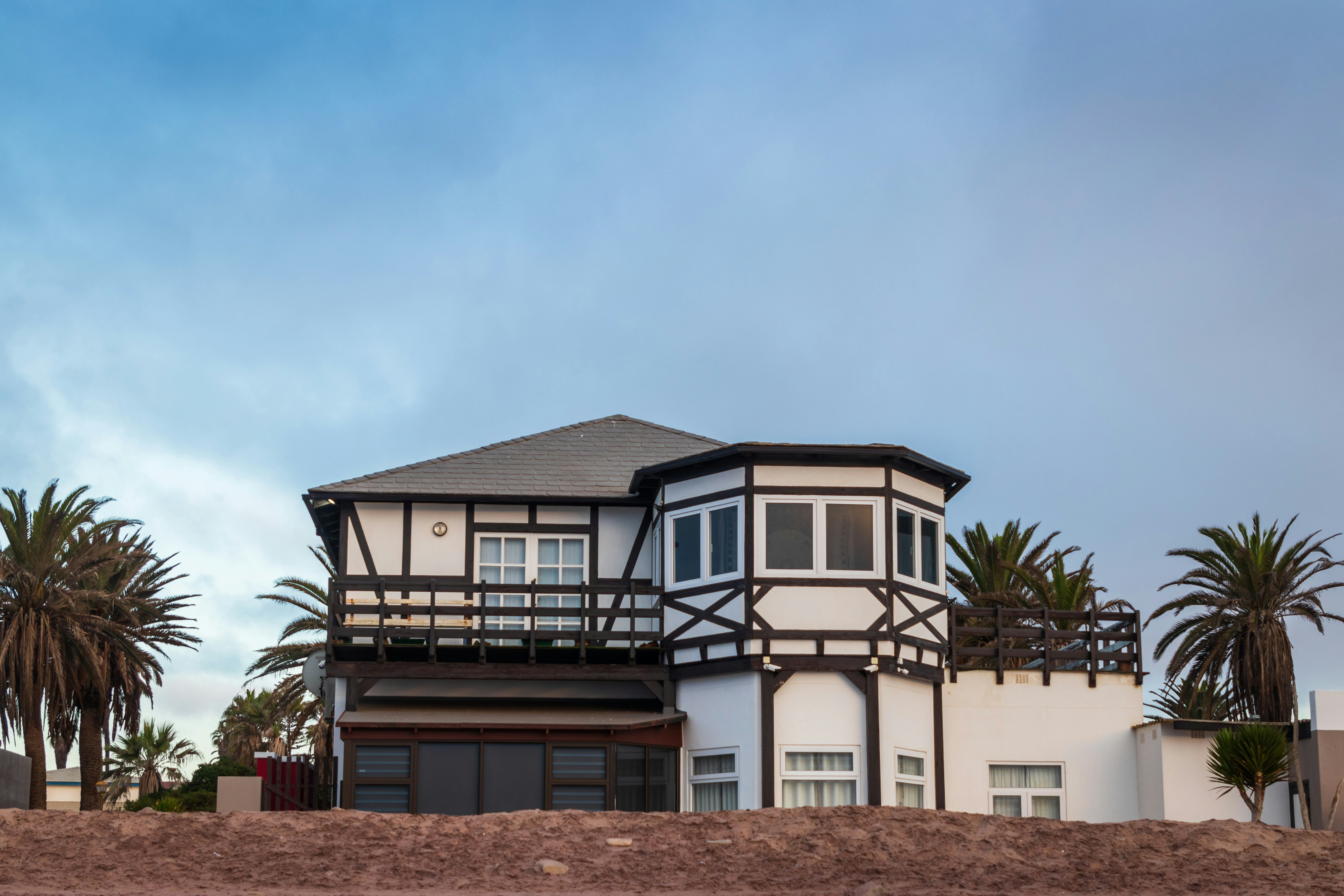 white and brown concrete house under blue sky during daytime