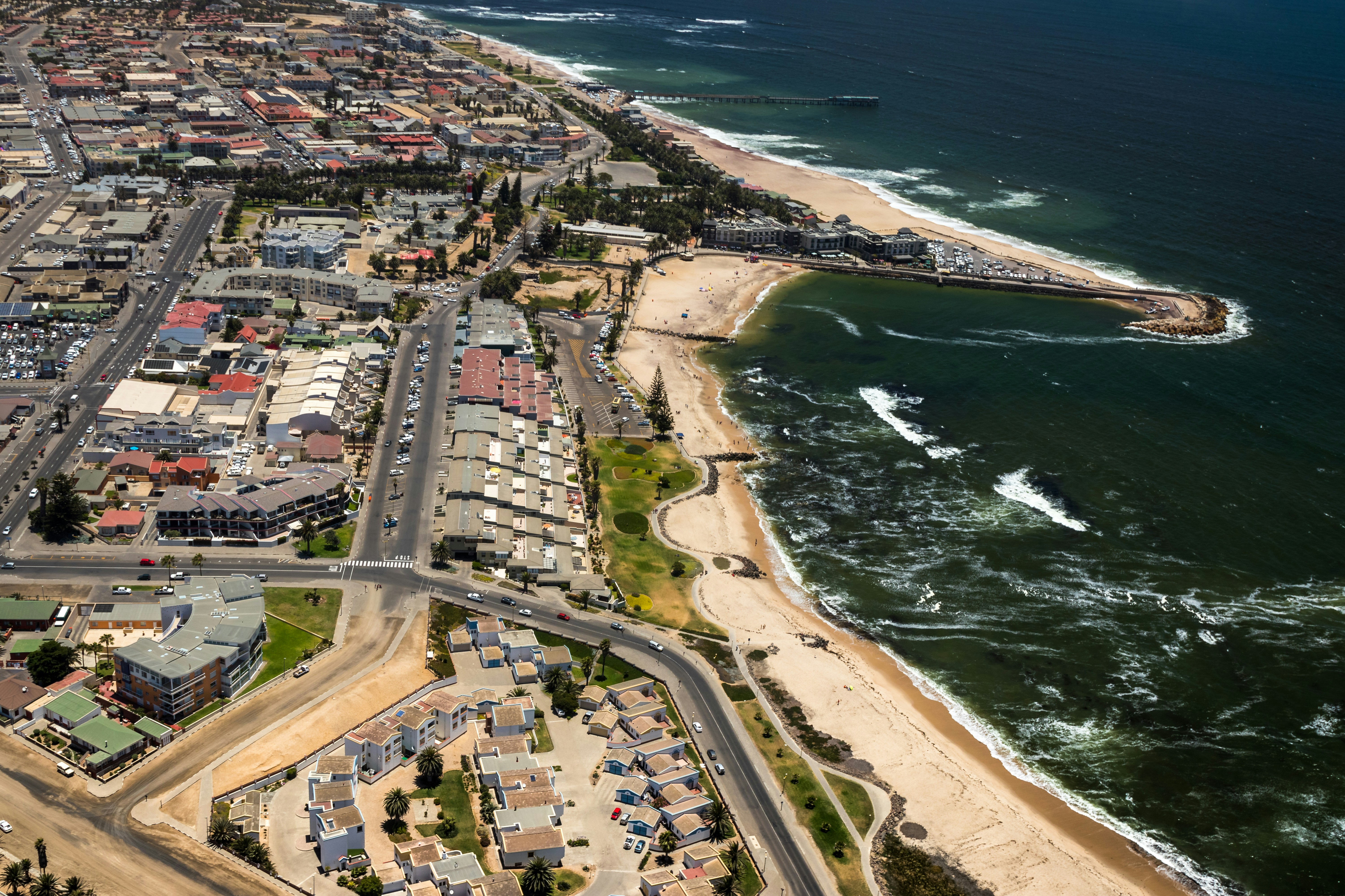 aerial view of city buildings near body of water during daytime