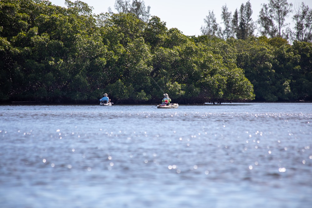 people riding on boat on river during daytime