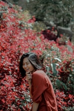 A vibrant photo of a woman laughing outdoors, surrounded by colorful art supplies.