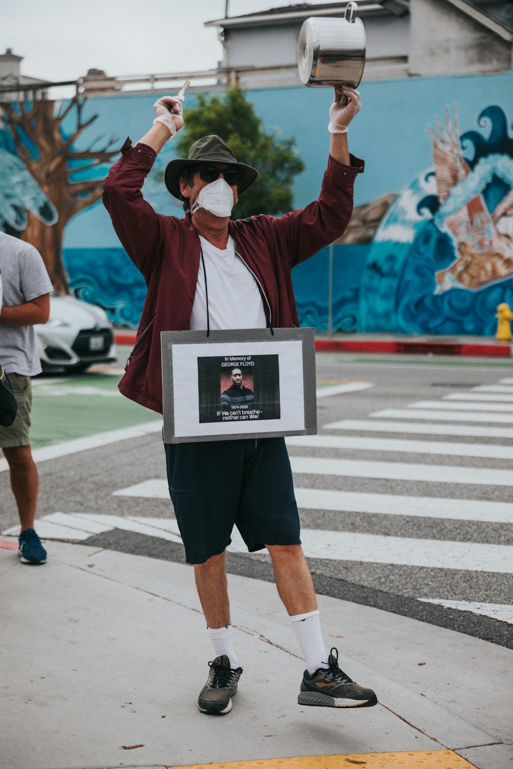 man in white jacket holding white photo frame