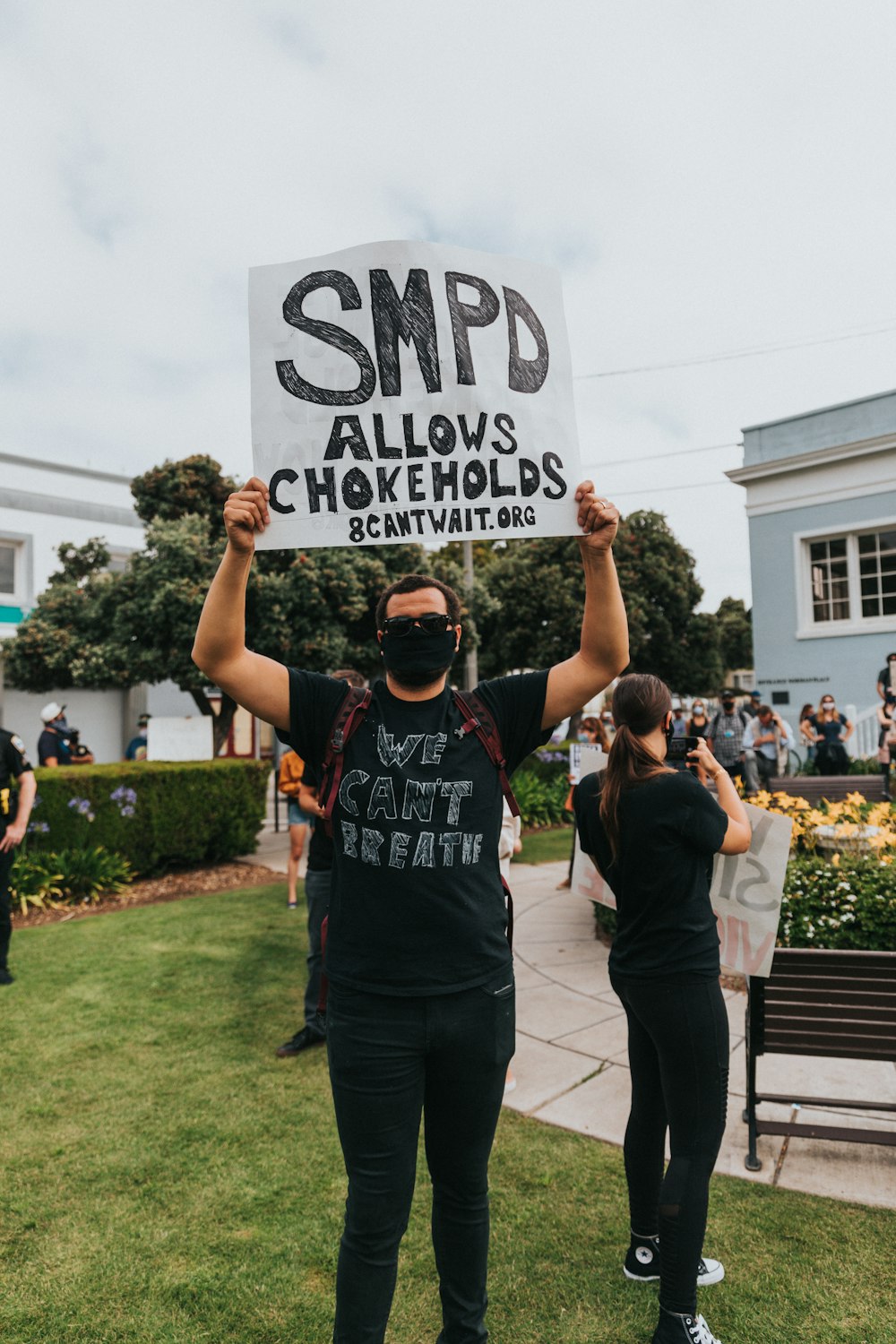 a man and woman holding up a sign