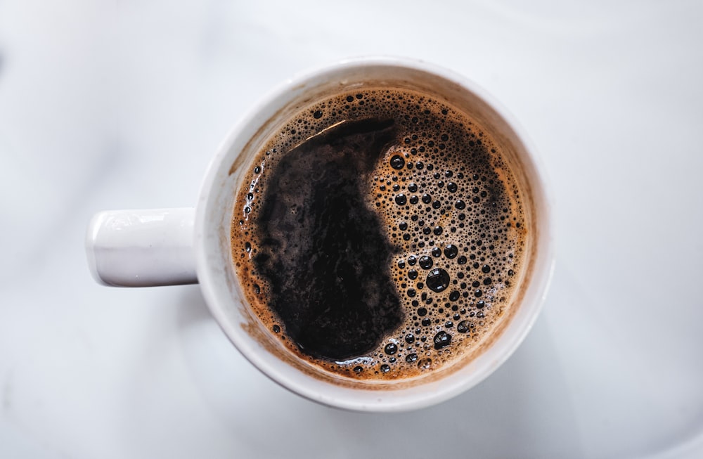 white ceramic mug with coffee