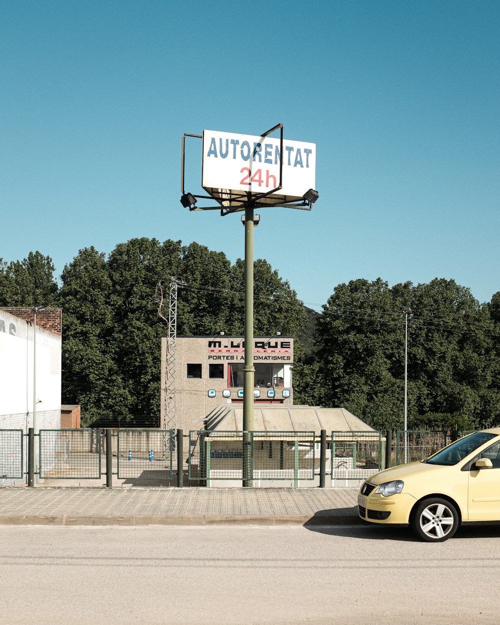 yellow car parked beside white and brown building