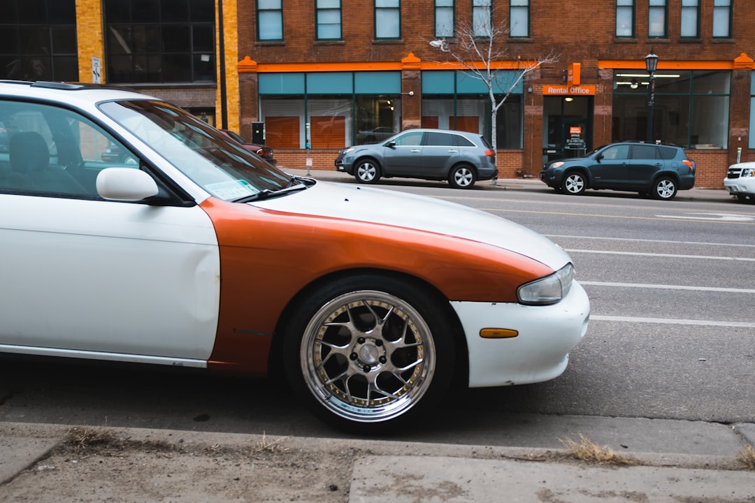 white and orange car on road during daytime