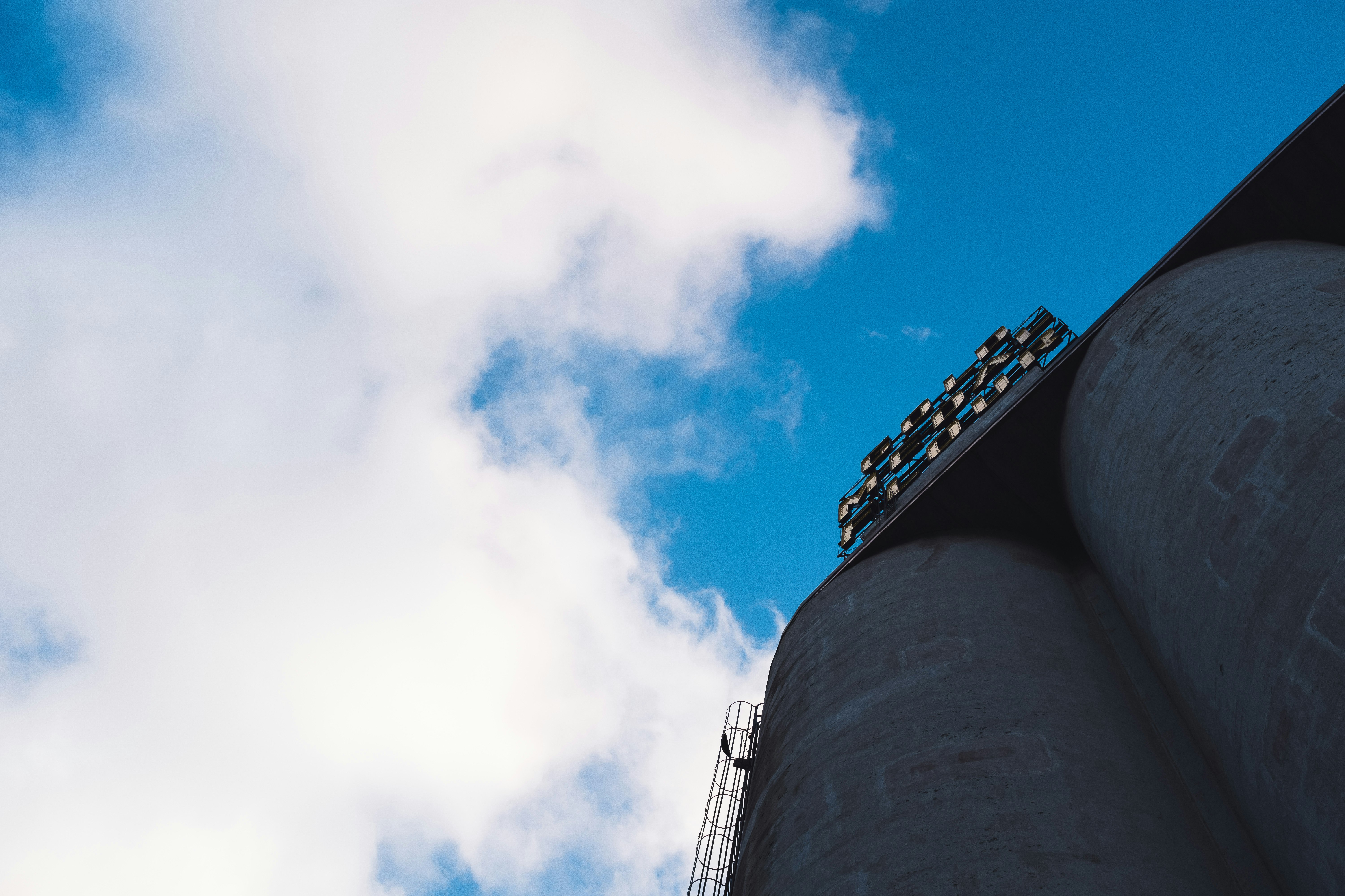 low angle photography of gray concrete building under blue sky during daytime