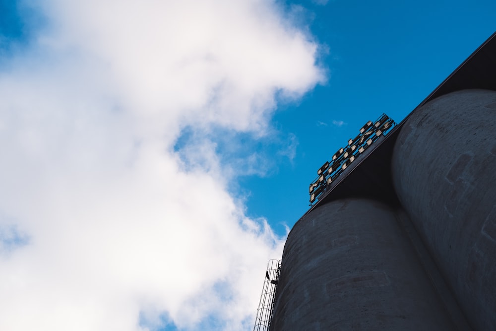 low angle photography of gray concrete building under blue sky during daytime