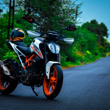 black and orange motorcycle on road during daytime