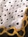 A fabric designed with repeating text 'I ❤️ JESUS' interspersed with black heart icons. A decorative pattern with yellow and orange chains is visible at the lower corner.
