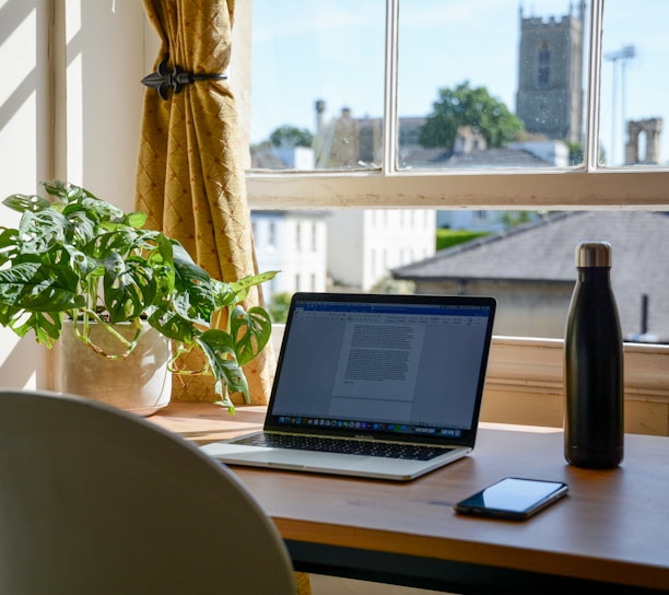 macbook pro on brown wooden table