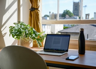 macbook pro on brown wooden table