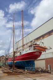 red and white boat on dock during daytime
