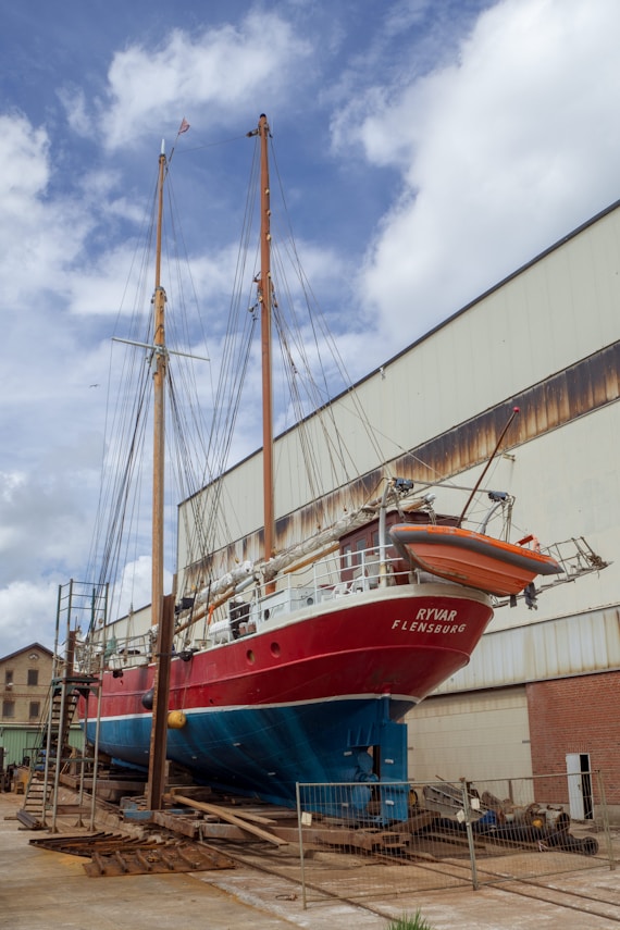 red and white boat on dock during daytime