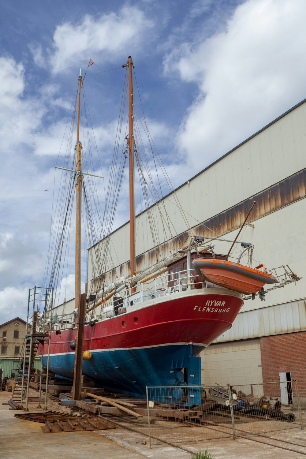 red and white boat on dock during daytime