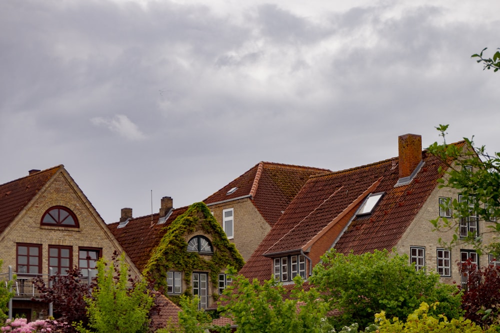 brown and white concrete house under white clouds during daytime