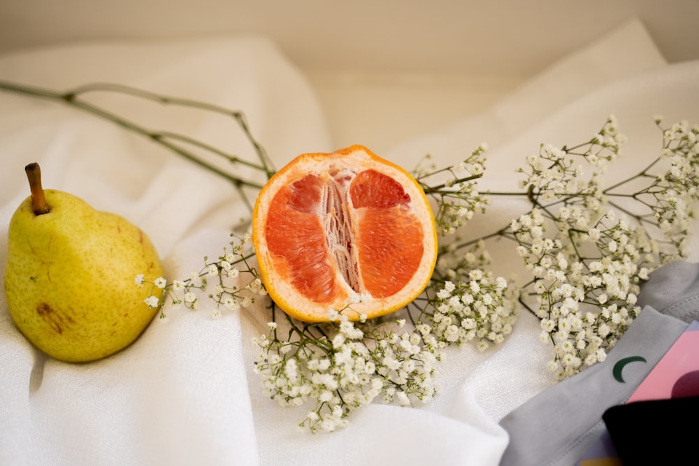 sliced orange fruit on white textile