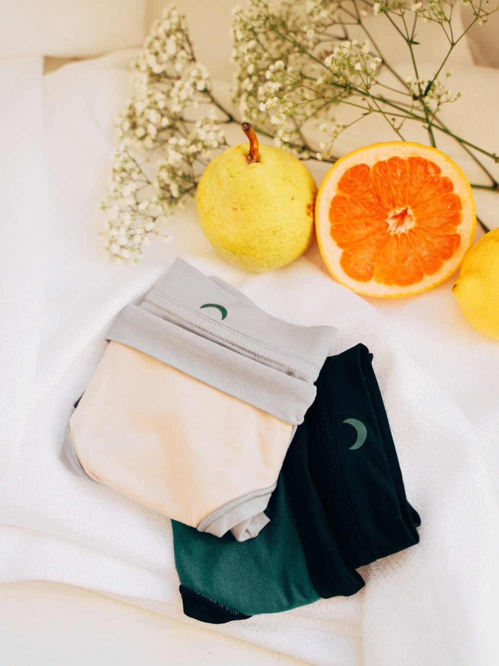 sliced orange fruit on white textile