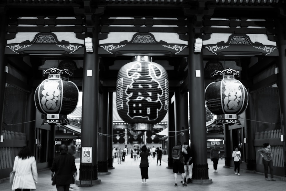 people walking on street in grayscale photography