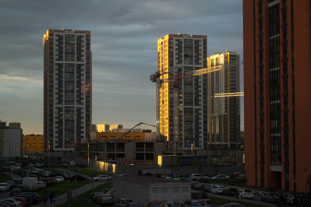 cars parked near high rise building during daytime