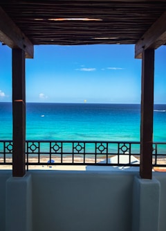 brown wooden frame near blue sea during daytime