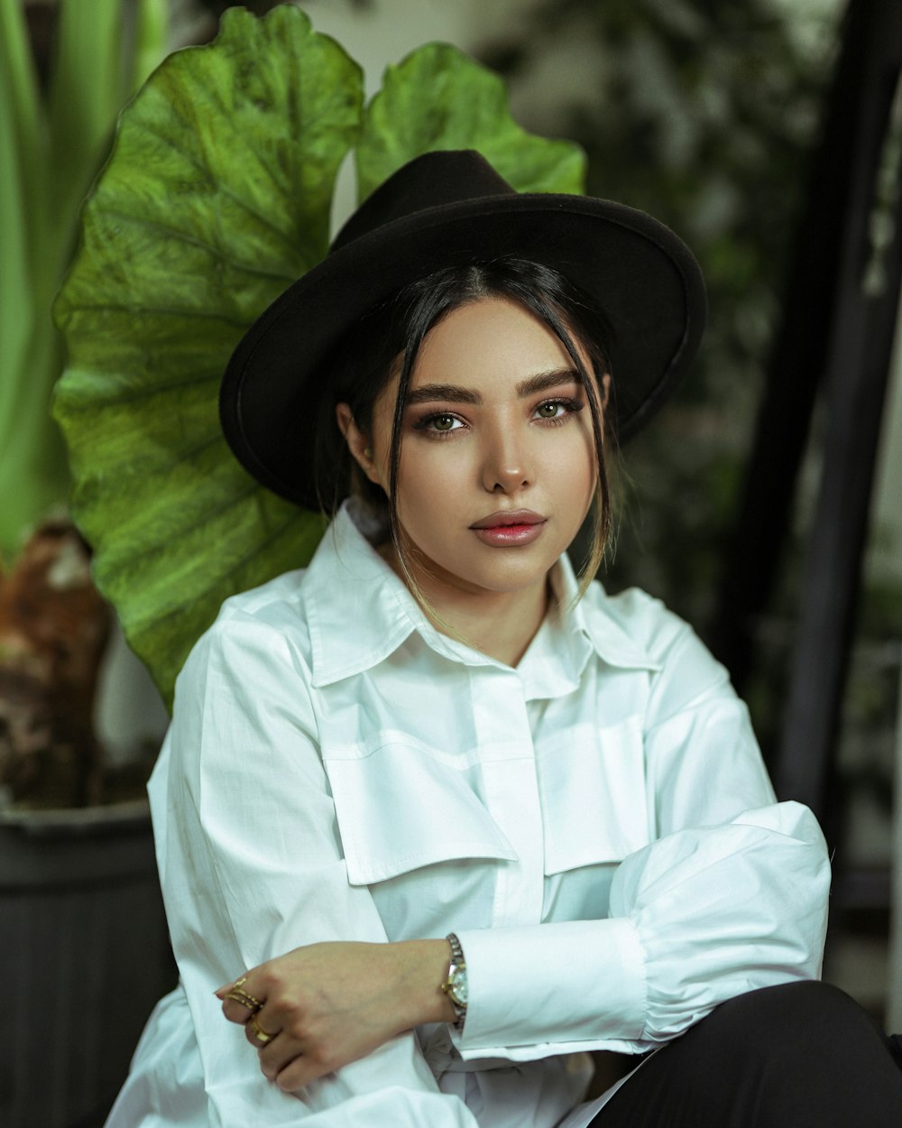 woman in white button up shirt wearing black hat