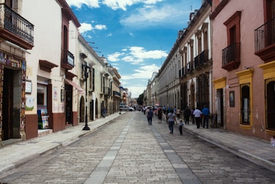 Tourists enjoying a guided walking tour through historic city streets under bright blue skies.