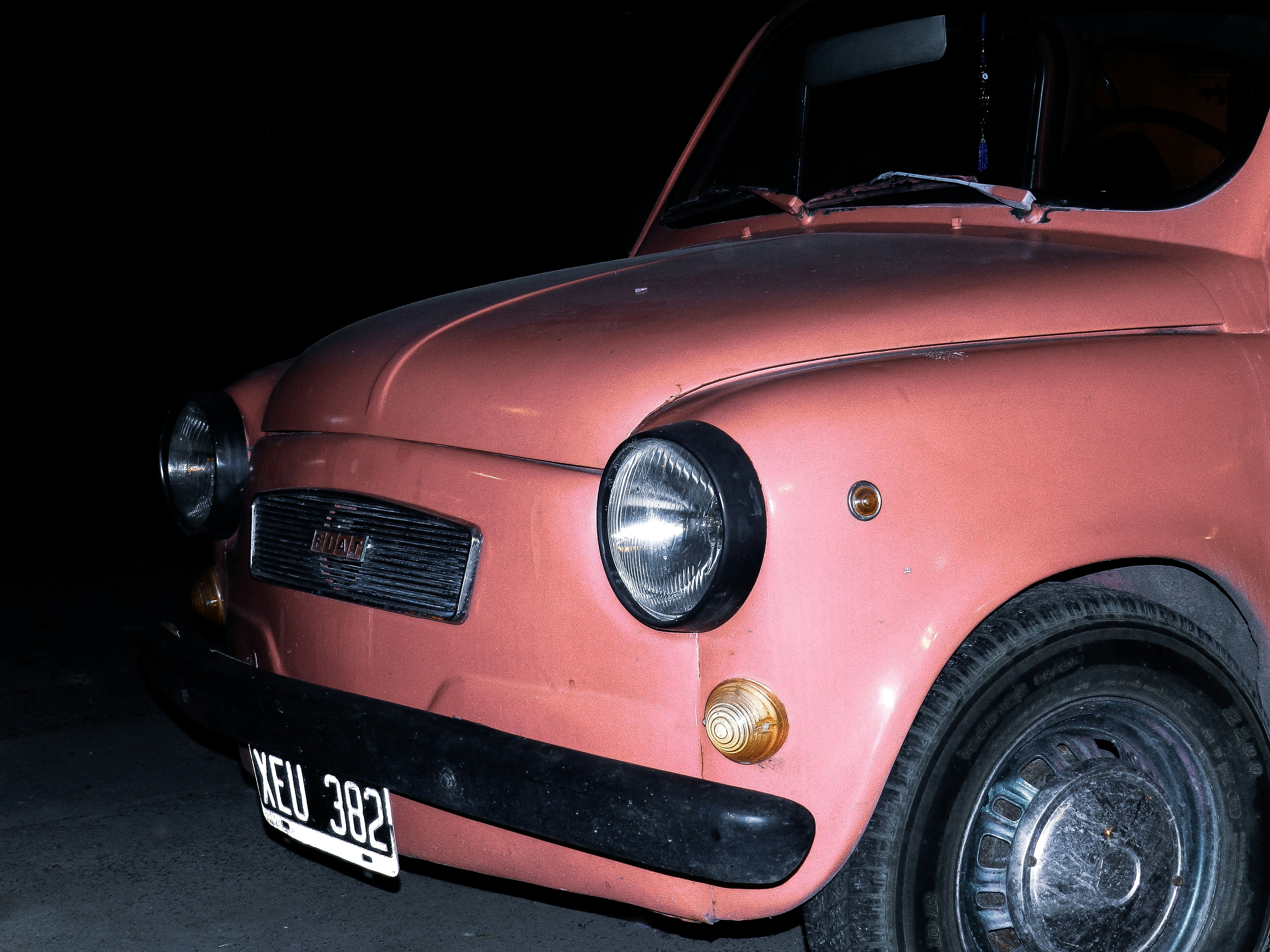 red car with black and white license plate