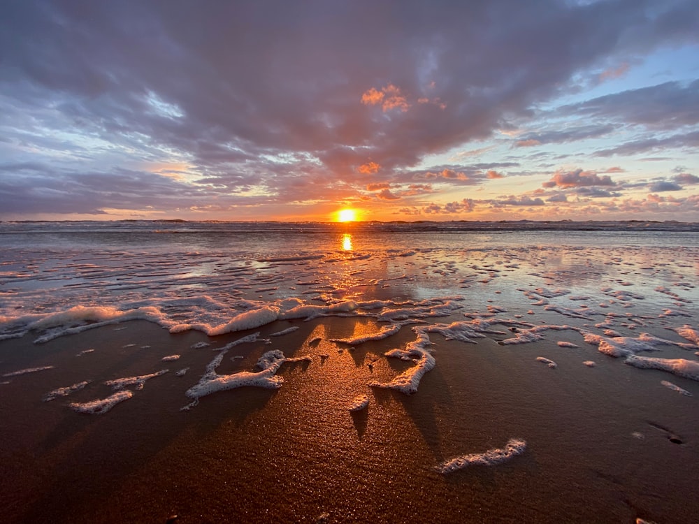 brown rocks on seashore during sunset