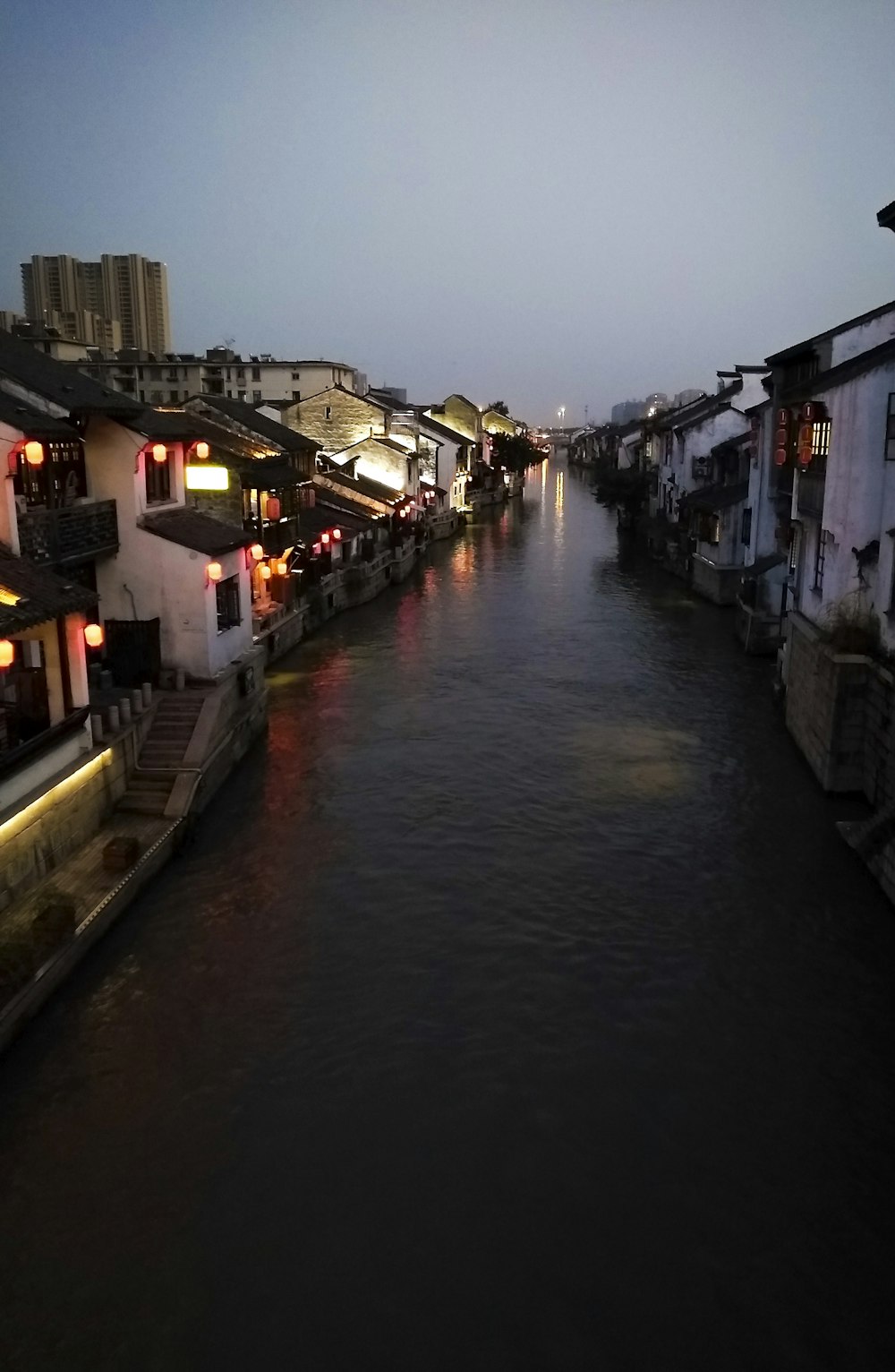 river between houses during night time