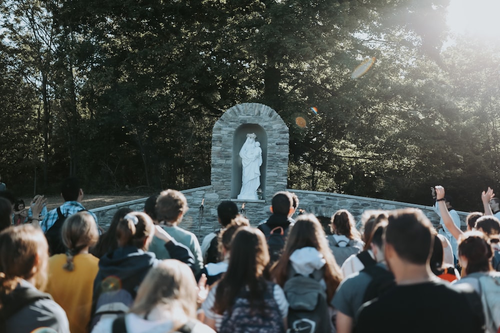 people standing near water fountain during daytime