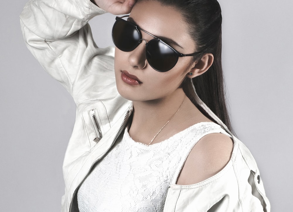 woman in white jacket wearing black sunglasses