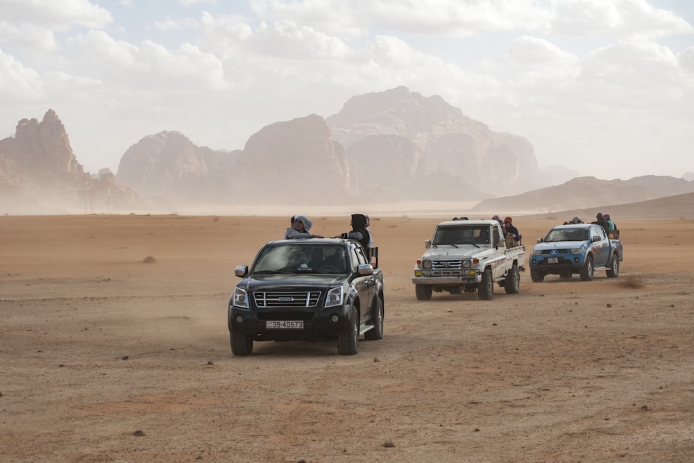 black car on brown sand during daytime