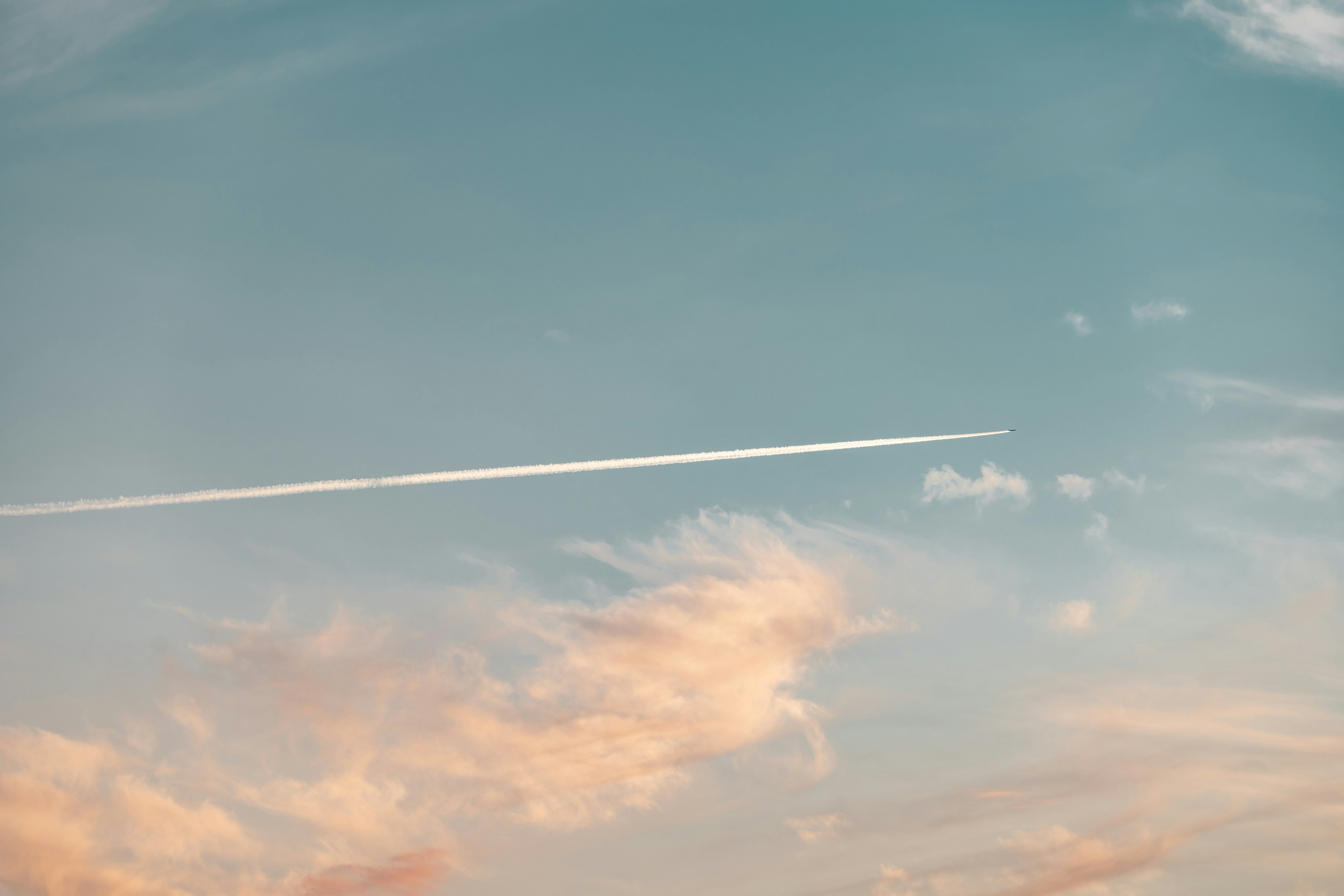 white clouds and blue sky during daytime, Sunset sky and clouds with an airplane track 