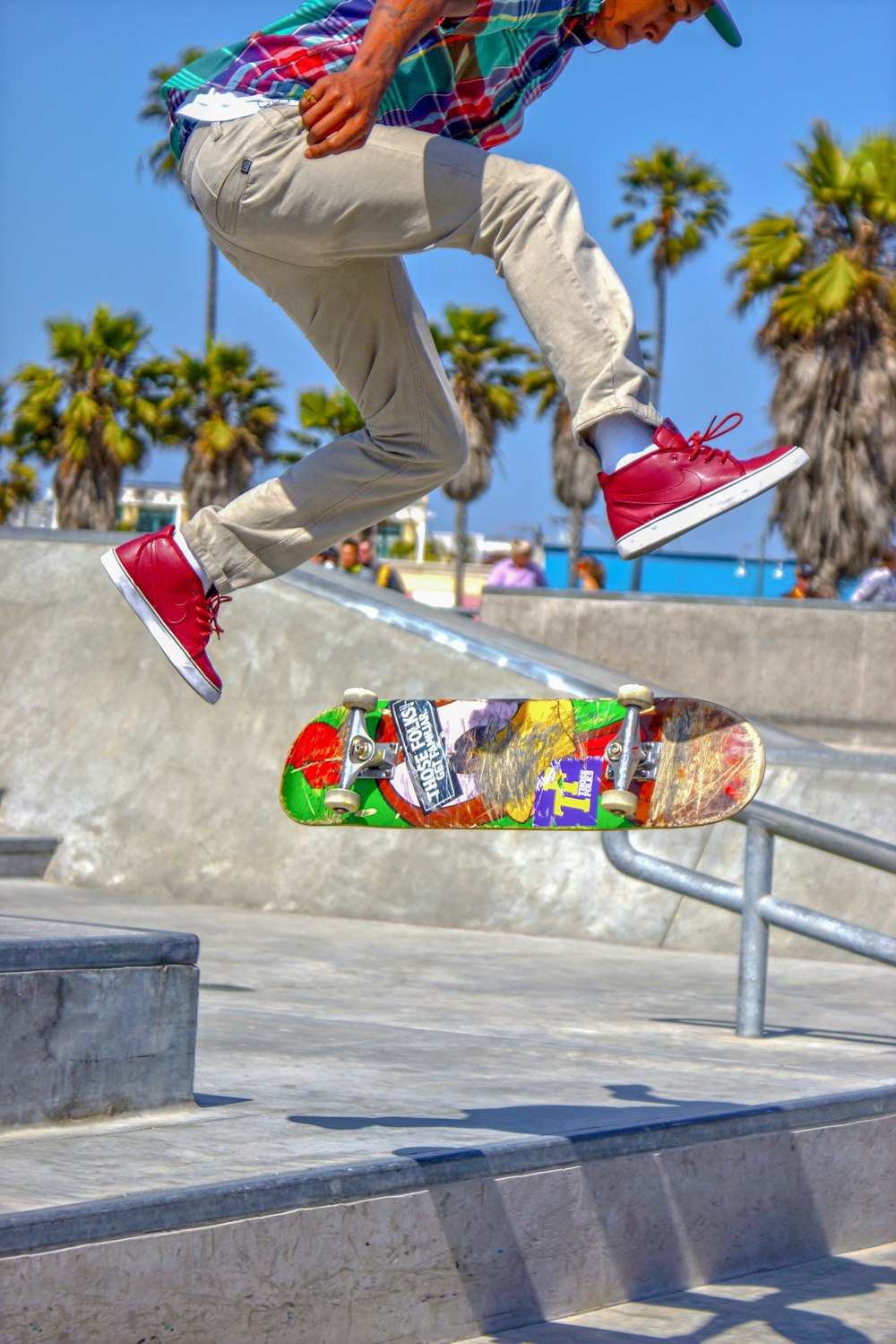 person in brown pants and red and white nike air force 1 high